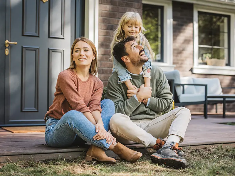 couple in front of new home
